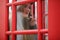 Beautiful young girl in a phone booth. The girl is talking on th