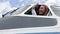 Beautiful young girl pilot sitting at the controls of an airplane,looks out the window