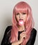 Beautiful young girl with pink hair, smile and brigth light with candy lolipop