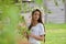 Beautiful young girl with plaits and daisies