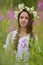 Beautiful young girl with plaits and daisies