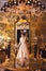 A beautiful young girl in a powdery wedding dress on the background of the interiors of a luxurious historical apartment.