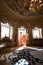 A beautiful young girl in a powdery wedding dress on the background of the interiors of a luxurious historical apartment.