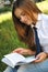 Beautiful young girl is reading a book