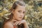 Beautiful young girl in a red dress on a background of foliage. lime toning