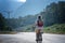 Beautiful young girl rides a bicycle on a beautiful mountain road. Summer holidays and cycling, sports and outdoor activities