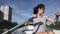 Beautiful young girl rowing on a boat on a lake