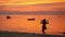 Beautiful young girl runs to the water spin around against the background of sunset on tropical beach. slow motion