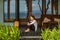 Beautiful young girl sits on the veranda the bungalow near the ocean beach in Bali island Indonesia