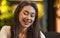 Beautiful young girl smiling at camera, chilling at cafe