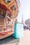 Beautiful young girl strolling through Paris next to the carousel, vintage atmosphere