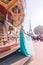 Beautiful young girl strolling through Paris next to the carousel, vintage atmosphere