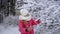 A beautiful young girl touches the snow lying