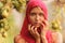 Beautiful young girl trying on a red scarf. Autumn time for harvest. Orchard. The concept of harvesting