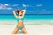 Beautiful young girl in turquoise bikini on a tropical beach. Bl