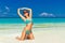 Beautiful young girl in turquoise bikini on a tropical beach. Bl