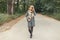 Beautiful young girl in a vintage coat and a warm scarf walks