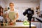 Beautiful young girl vlogger live cooking at kitchen for working from home.