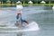 Beautiful young girl wakeboarding at lake