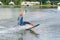 Beautiful young girl wakeboarding at lake