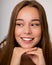 Beautiful young girl woman openly smiling snow-white smile. Healthy, even teeth, clean skin. Dental concept. Close up Studio