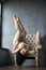 Beautiful young gymnast on a chair took an unusual fashion pose