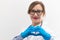 Beautiful young happy doctor woman in medical gloves and glasses with a stethoscope in the hospital shows hand gestures