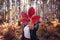 Beautiful young happy girl with a bright red autumn leaf in the park or forest, autumn fall concept, Autumn leaves in girl hands.