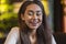 Beautiful young happy girl looking at camera, chilling at cafe