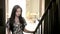 Beautiful young hispanic girl with long black hair graceful up stairs. concept lifestyle fashion and beauty