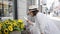 Beautiful young hispanic woman smiling taking picture of  flowers in the streets of Stockholm