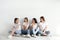 Beautiful young ladies in jeans and white t-shirts near light wall. Woman`s Day