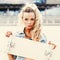 Beautiful young lady with a skateboard with blank deck