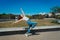 Beautiful young latina dancing happily in the street while partying with jumps and somersaults. Concept of joy, street dance, hip