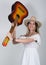 Beautiful young leggy blond Country girl in a litl white dress and cowboy hat with a guitar