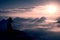 Beautiful young long hair girl tourist enjoy daybreak on the sharp corner of sandstone rock and watch over valley to Sun.