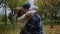 Beautiful young lovers kissing romantically in autumn park. Close up of couple.