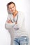 Beautiful young man leaning against white wall