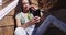 Beautiful young mixed ethnic woman looking at cellphone on stairs