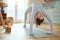 Beautiful young mixed race woman practicing yoga at home. Hispanic female doing pilates exercise as part of her workout