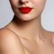 Beautiful young model with red lips and french manicure. Part of female face with red lips. Close-up shot of woman lips with gloss