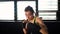 Beautiful young moving boxing woman training punching in fitness studio