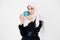 Beautiful young muslim woman holding little planet earth globe near her face with care and responsibility, isolated on