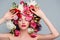 beautiful young naked woman with closed eyes posing with flowers on head