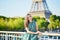 Beautiful young Parisian woman near the Eiffel tower