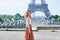 Beautiful young Parisian woman near the Eiffel tower