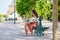 Beautiful young Parisian woman sitting on the bench