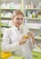 Beautiful young pharmacist girl holding medicine box