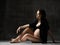 Beautiful young pregnant happy mother woman posing in underwear on dark