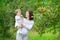 Beautiful young pregnant woman and her laughing baby daughter